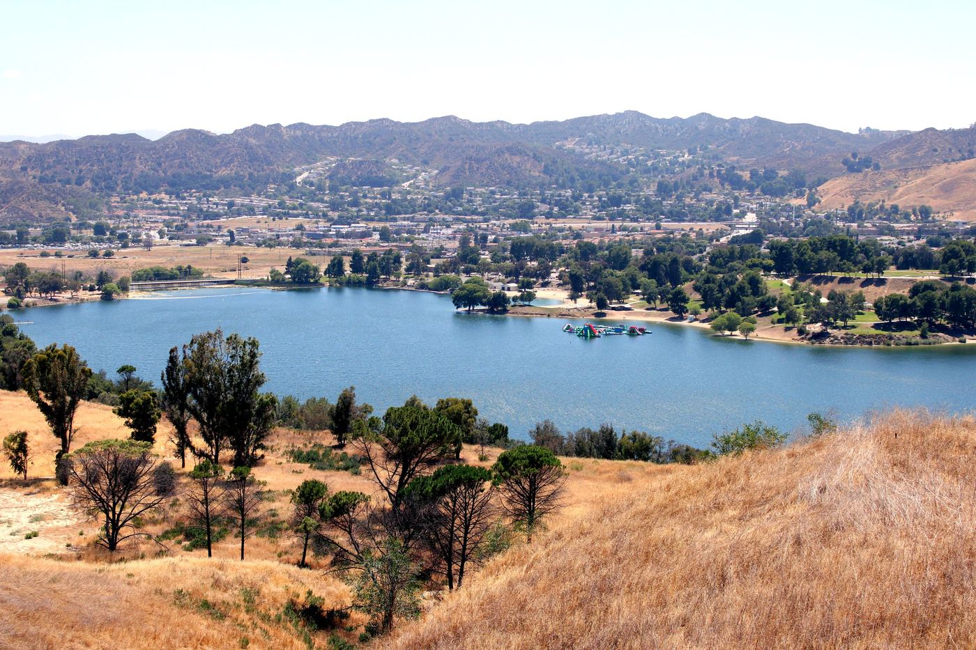 View of Castaic Lake with Santa Clarita hillside homes in the distance, fall real estate market in Castaic CA