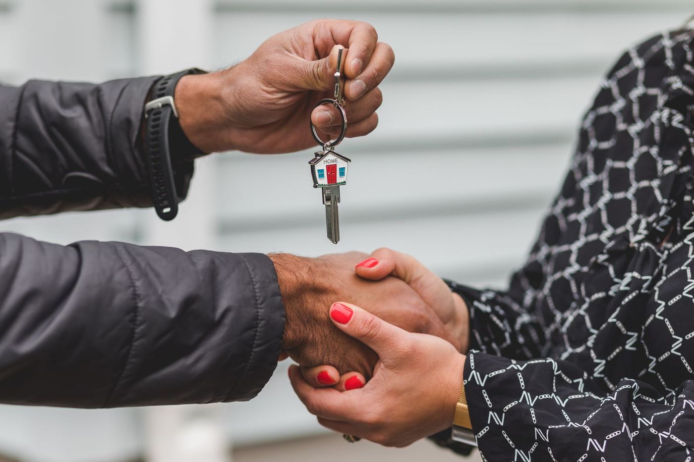 Hands exchanging house keys, symbolizing choosing a home in Newhall or Canyon Country, Santa Clarita