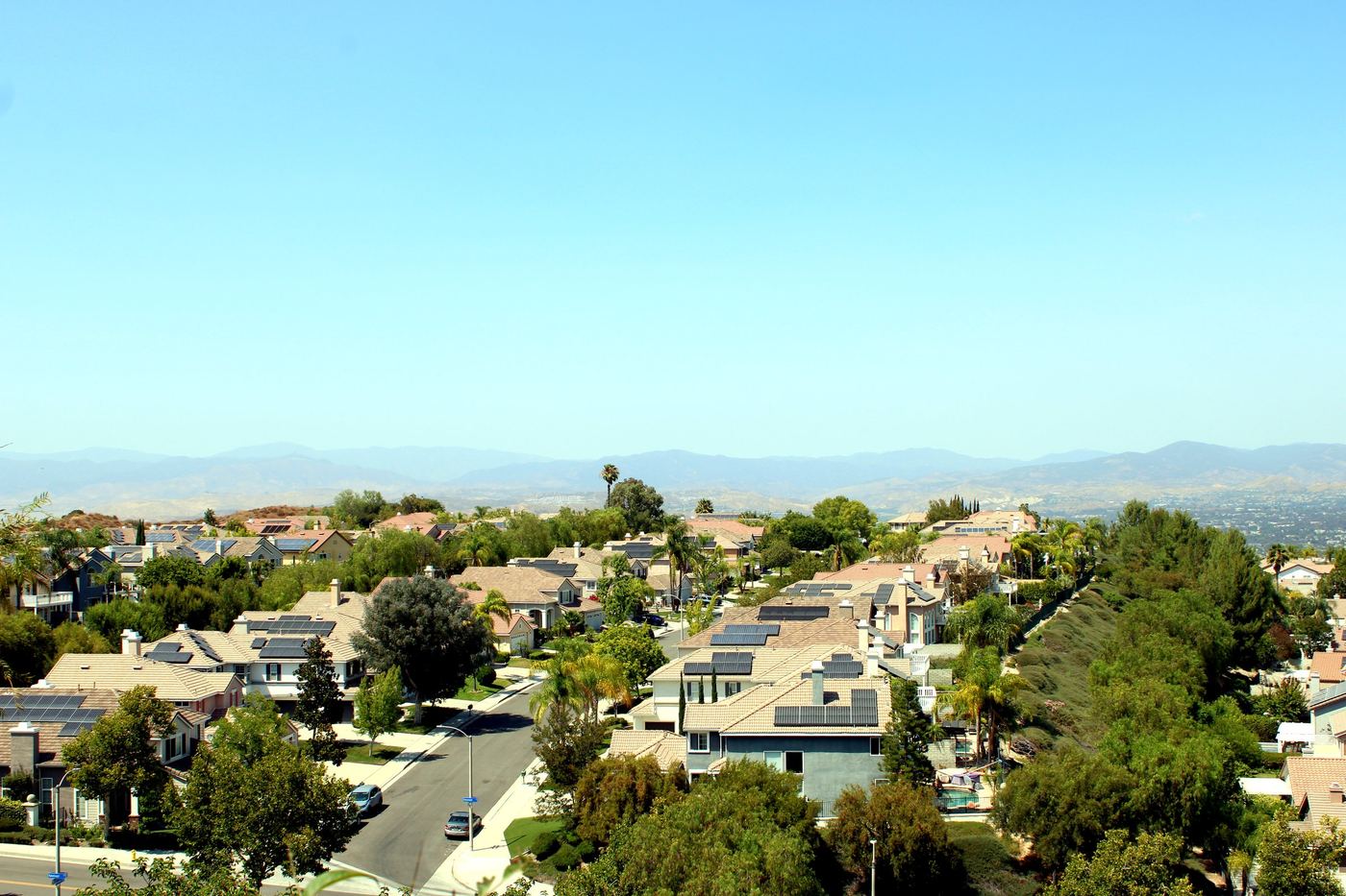 Elevated view of a Stevenson Ranch hillside neighborhood street lined with homes, Santa Clarita
