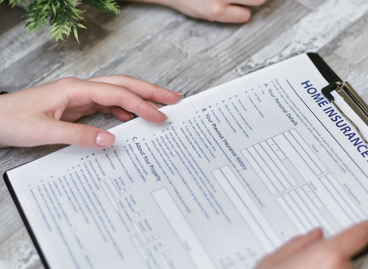 Reviewing a home insurance policy document, Santa Clarita home buying